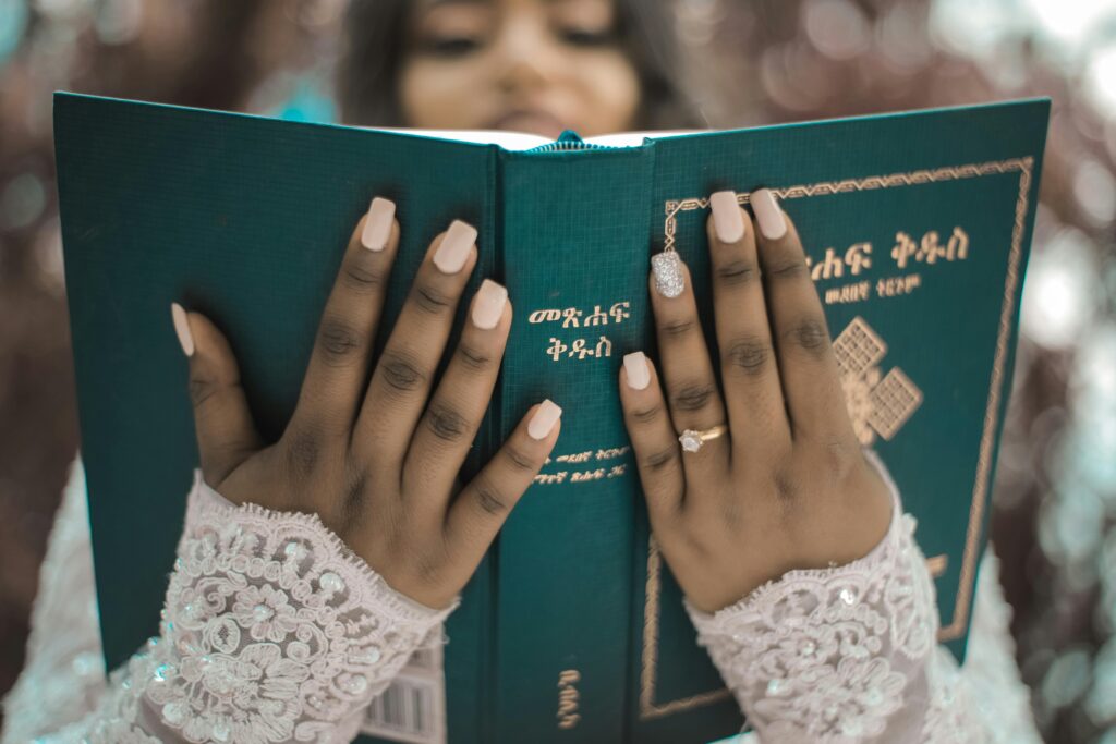 A bride reading her wedding vows with a book.